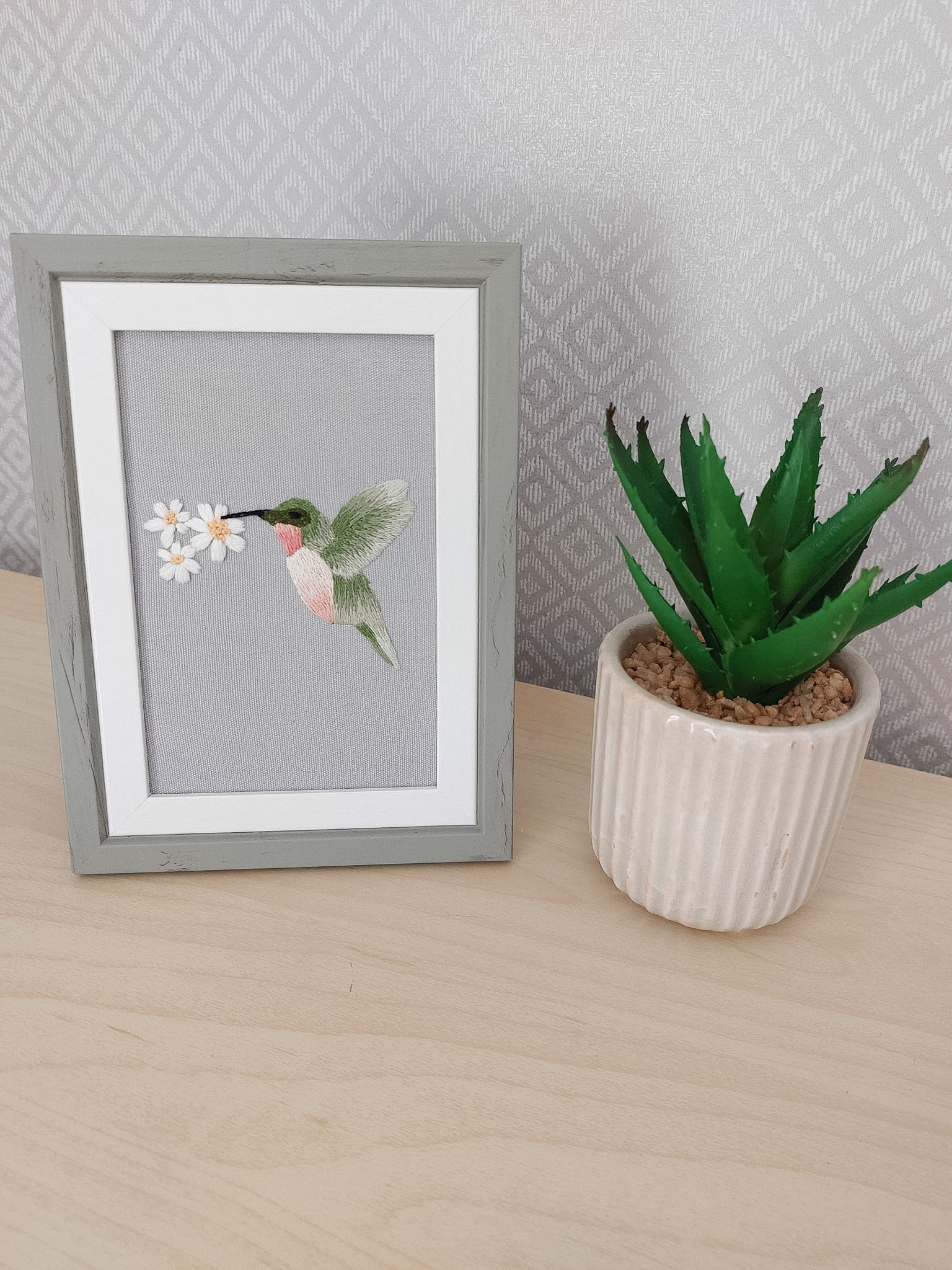 Angela's 'Hummingbird' pattern, stitched with the thread painting technique that she learned in the embroidery membership, Bloom Embroidery Academy. Framed in a 6x4 frame and displayed proudly in her home!