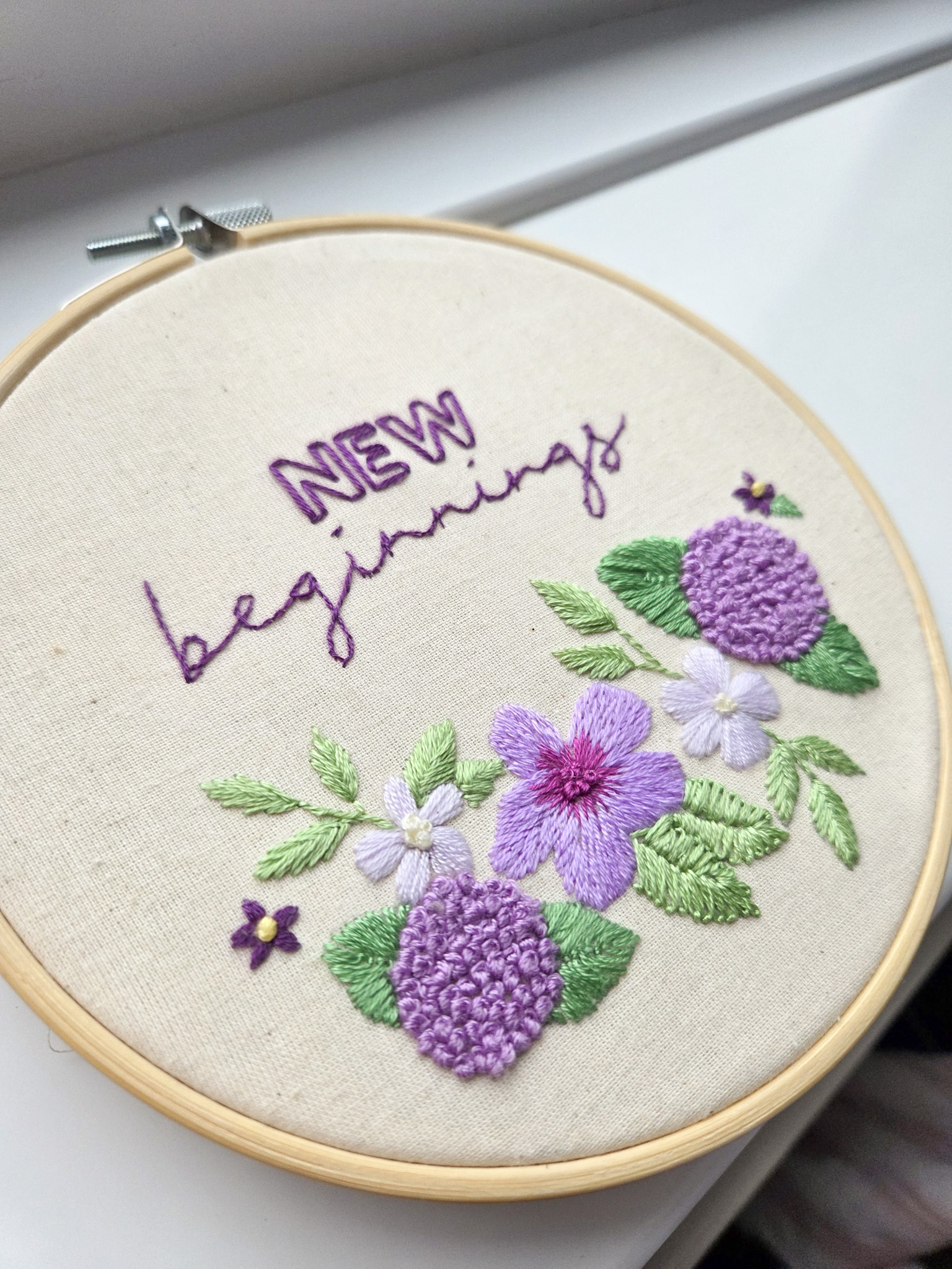 Angela's finished 'New Beginnings' embroidery pattern from Bloom Embroidery Academy's 'outline challenge'. A challenge inside the embroidery membership to choose your own embroidery stitches and colours.