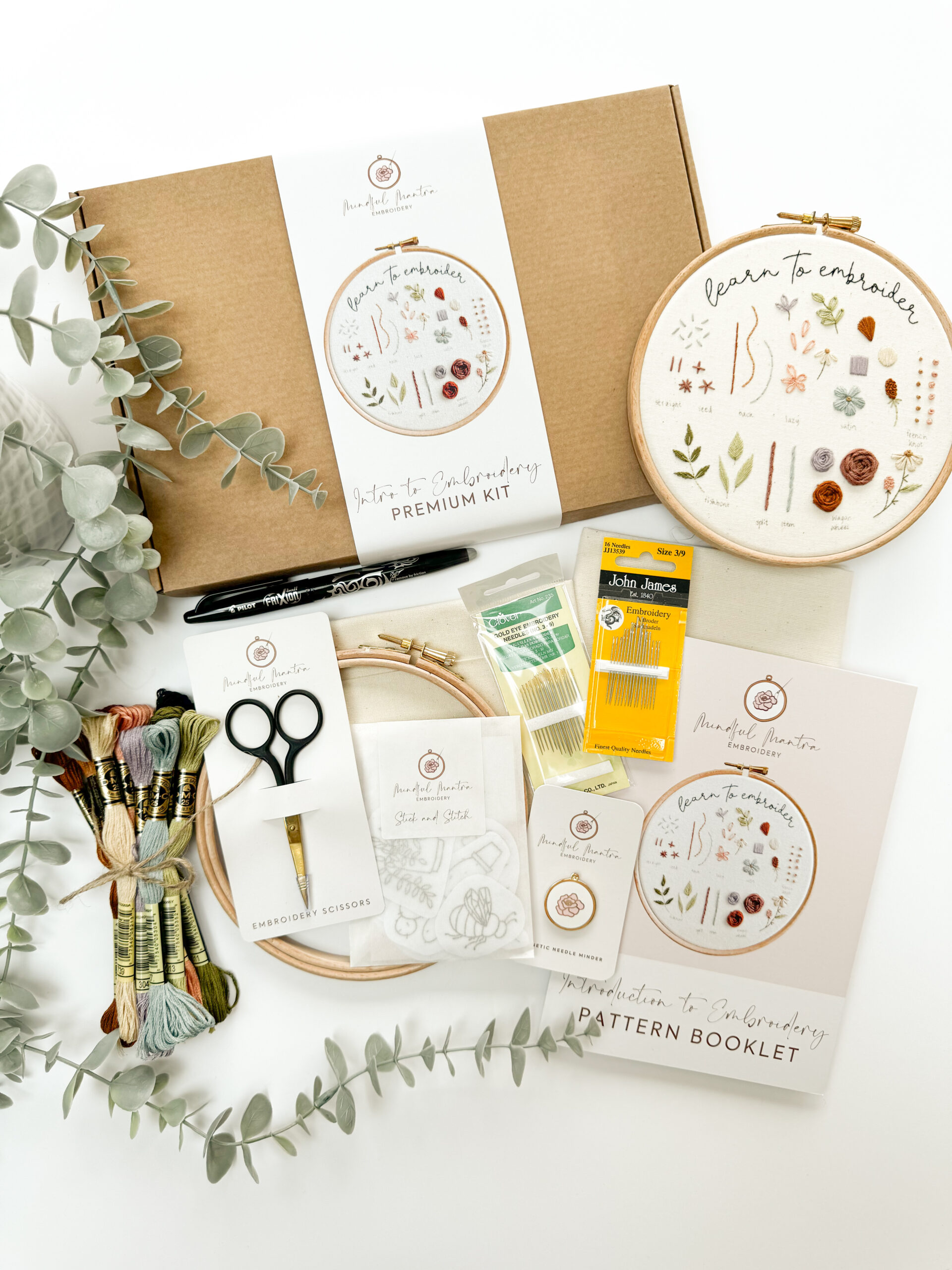A flatlay of embroidery supplies - the contents of the Introduction to Embroidery Kit from Mindful Mantra Embroidery