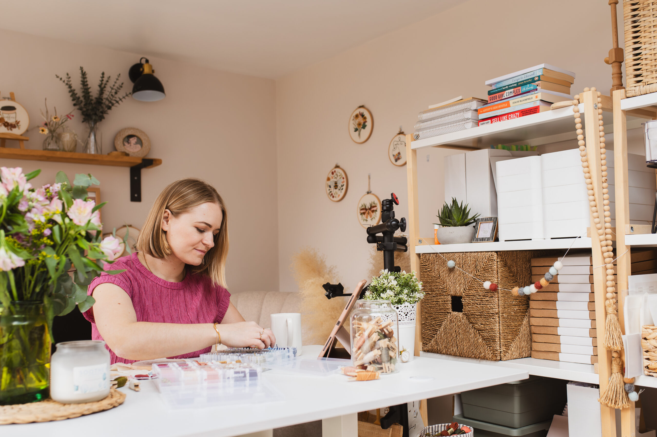 Sophie sat at her desk in her studio, choosing embroidery thread colours for her next embroidery pattern for the bloom embroidery academy membership